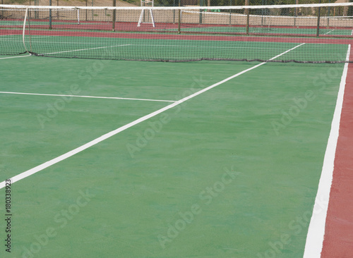 Closeup of outdoor clay tennis court with net © Paul Vinten