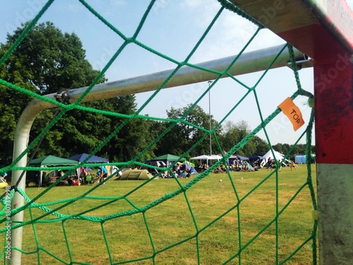 Shot through handball goal at a local diverse ball sports festival over a weekend during summer.