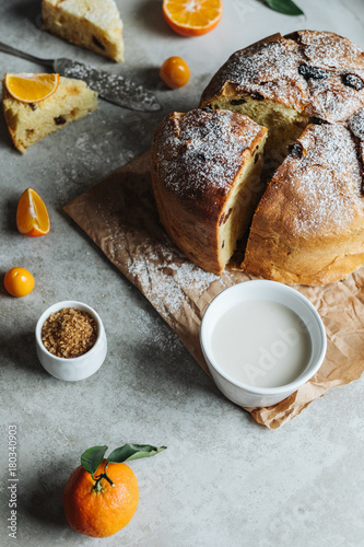 Traditional Christmas Panettone. Homemade cake and slice with oranges and raisins.