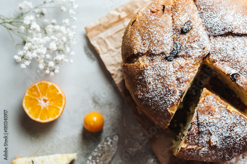 Panettone, traditional Italian Christmas cake. Top view close-up with sliced oranges.