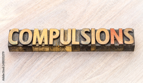 compulsions word abstract in wood type