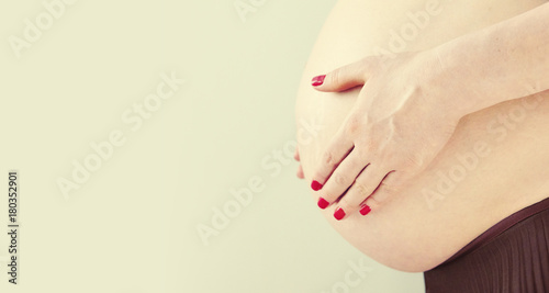 Wallpaper Mural Close up of pregnant woman touching her belly with hands. Side view of belly of a pregnant woman. It's a boy... Torontodigital.ca