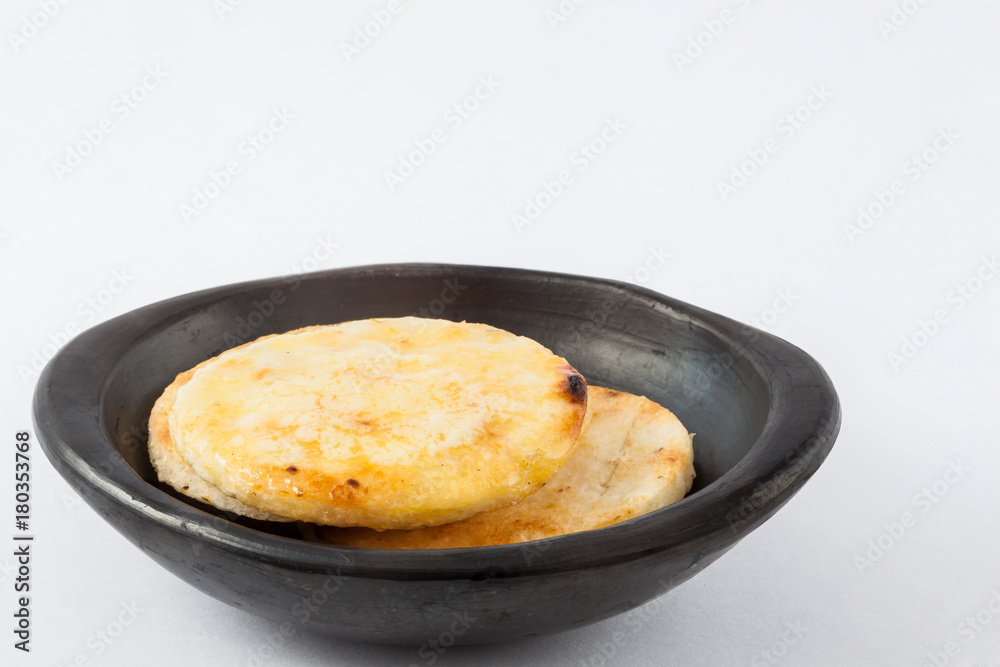 Traditional Colombian arepa topped with melted butter Traditional Colombian arepa topped with melted butter