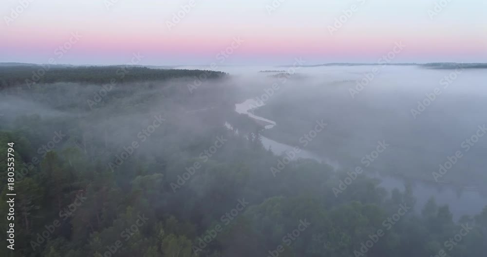 Drone shot flying low over foggy forests and river at dawn in Gauja National Park, Latvia Drone shot flying low over foggy forests and river at dawn in Gauja National Park, Latvia