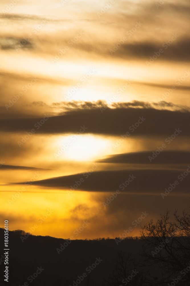 sky landscape at sunset with clouds in golden tones