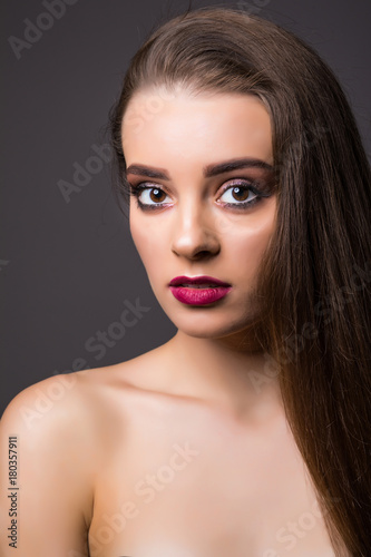 Beautiful woman with professional make up on dark background