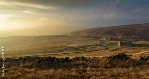 Beautiful autumn scenery in the Peak District - sun setting over Macclesfield road and Peak View Tea Rooms, scenic valley in the distance with dramatic storm clouds  photo