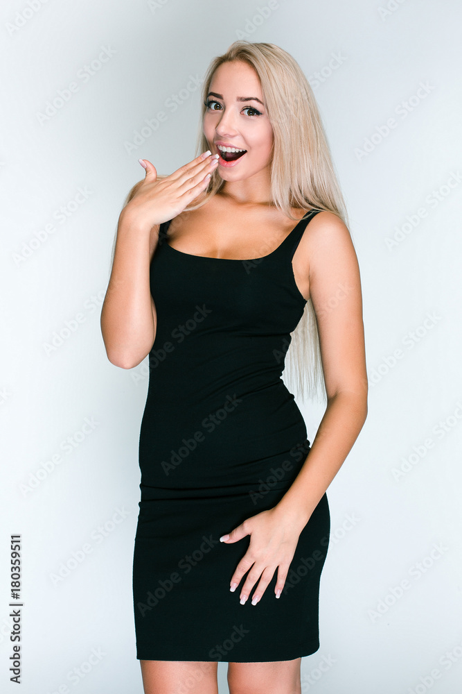 Is this ring for me? Beautiful young woman with blond hair looking shocked while standing against grey background Is this ring for me? Beautiful young woman with blond hair looking shocked while standing against grey background