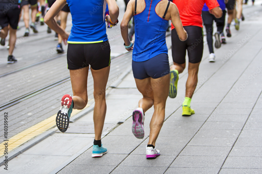 Marathon runners race in city streets, blurred motion Marathon runners race in city streets, blurred motion