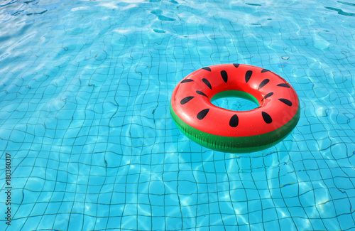 watermelon pool float, ring floating in a refreshing blue swimming pool