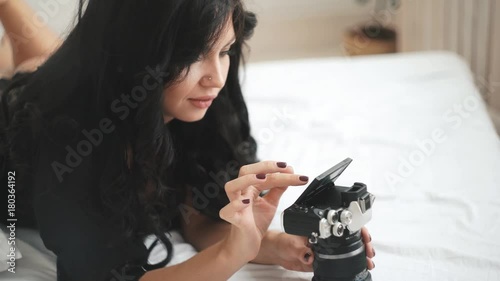 Sensual woman takes a photo of an new camera photo