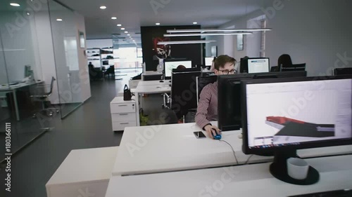People sit in the office behind computers and work
