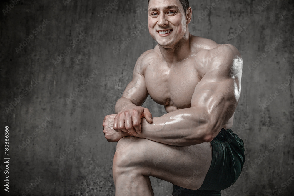 Fototapeta premium Handsome model young man posing in gym