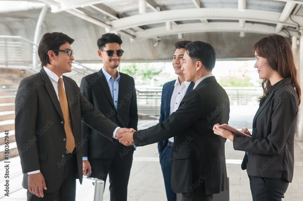 Asian business people complete business agreement and do hand shake to be partner. Asian business people complete business agreement and do hand shake to be partner.