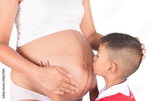 Cute asian boy kiss belly mom