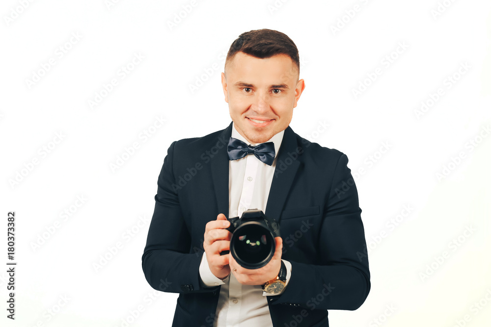 Fototapeta premium man photographer with a camera in hands on a white background