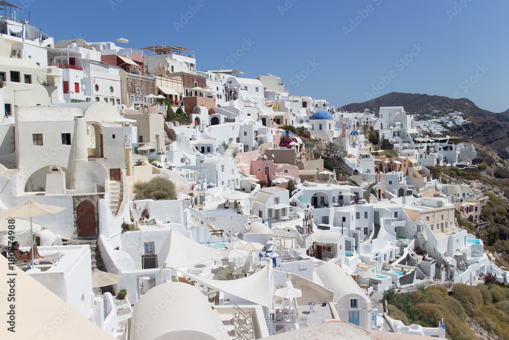 Landscape panorama with white houses and ancient wind mill in the Oia, Greece