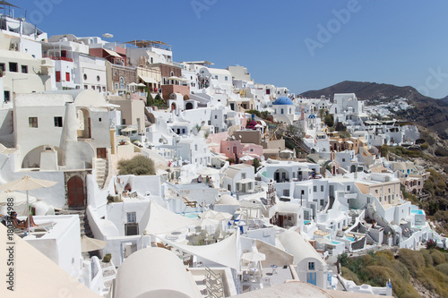 Landscape panorama with white houses and ancient wind mill in the Oia, Greece