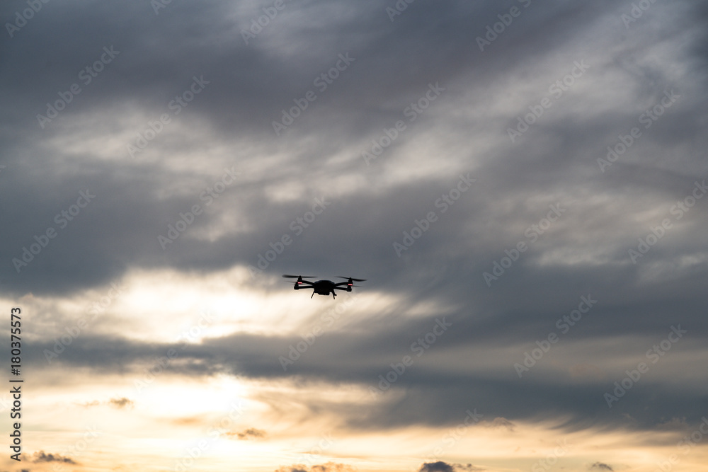 Drone flying against clouds 