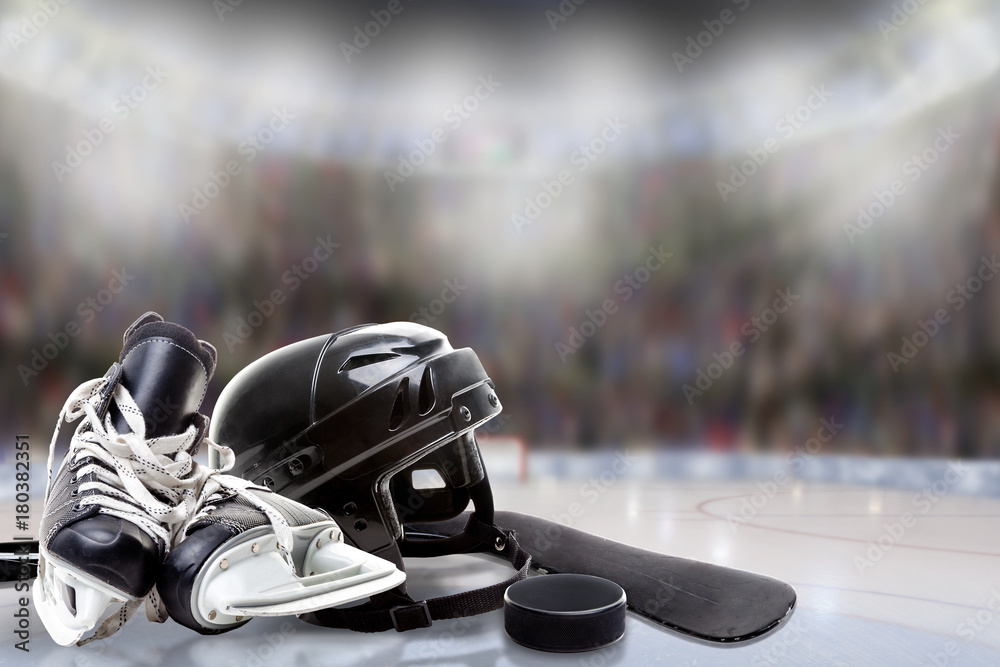 Obraz premium Ice Hockey Helmet, Skates, Stick and Puck in Rink