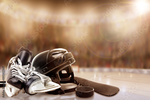 Ice Hockey Helmet, Skates, Stick and Puck in Fictitious Rink With Special Lighting Effects and Copy Space