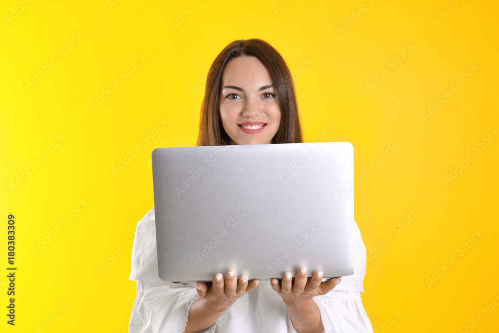 Young woman with laptop on color background. Internet shopping concept Young woman with laptop on color background. Internet shopping concept