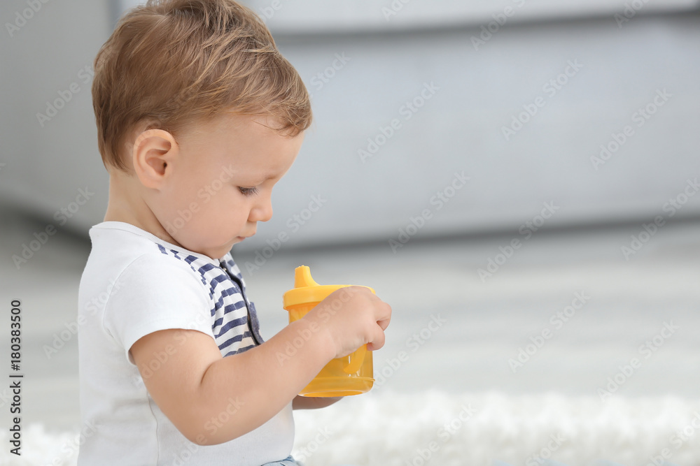Adorable baby with drinking bottle at home Adorable baby with drinking bottle at home