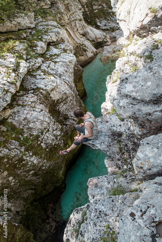 high angle view on a man sitting on a rock