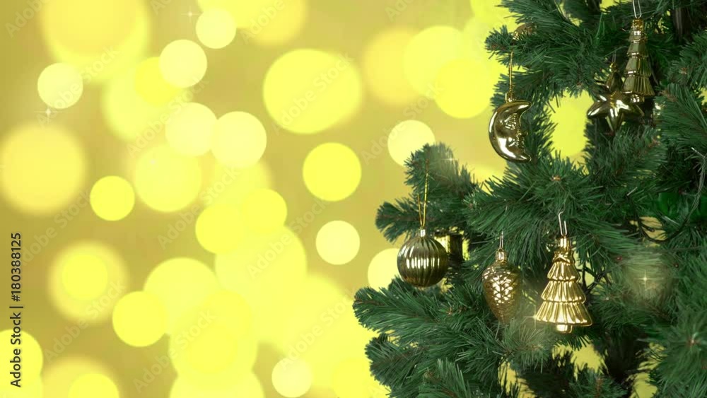 Green christmas tree rotate with gold decor on branches. Flickering ...