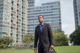 Young handsome African American man walking to work, looking sharp and confident