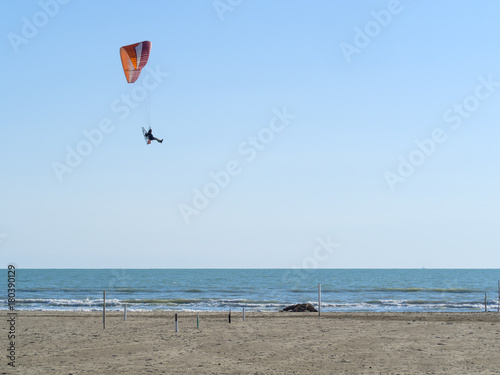 Paramotor or Powered Paragliding flying on the beach and sea