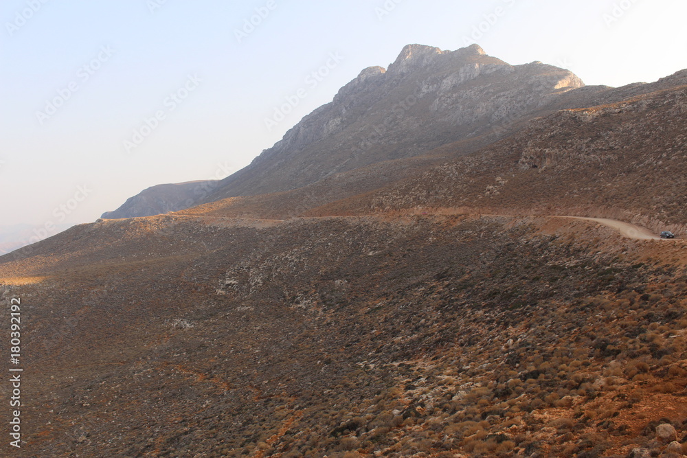 Rough Balos Lagoon (or Balos Beach) trail landscape in northwestern part of Crete Island, Greece. After 10 kms of bumpy car road, about 7 kms of footpath leads to the famous beach. Rough Balos Lagoon (or Balos Beach) trail landscape in northwestern part of Crete Island, Greece. After 10 kms of bumpy car road, about 7 kms of footpath leads to the famous beach.
