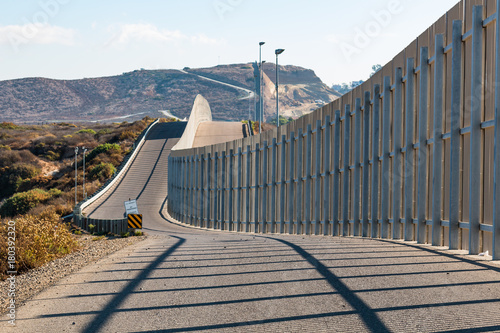 The international border wall between San Diego, California and Tijuana, Mexico, as it begins its journey from the Pacific coast and travels over nearby hills.  