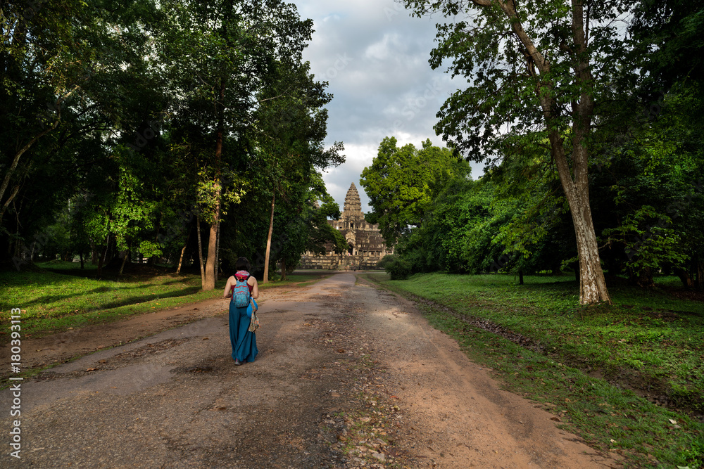 Tourist girl walking to Angkor wat temple - Cambodia 