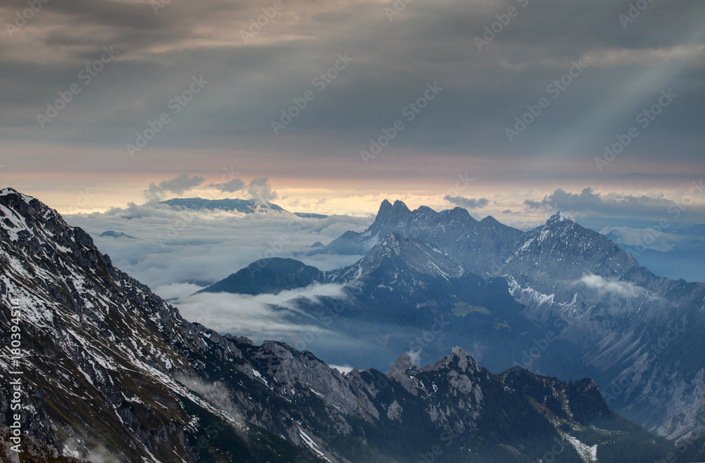 Autumn morning fog and sun rays at dawn near jagged Koschutnikturm Kosutnikov tower peak, Koschuta Kosuta range Karawanken Karavanke mountain, Loibl Ljubelj pass, Carinthia Austria, Gorenjska Slovenia