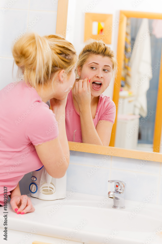 woman removing peel off mask from her face woman removing peel off mask from her face