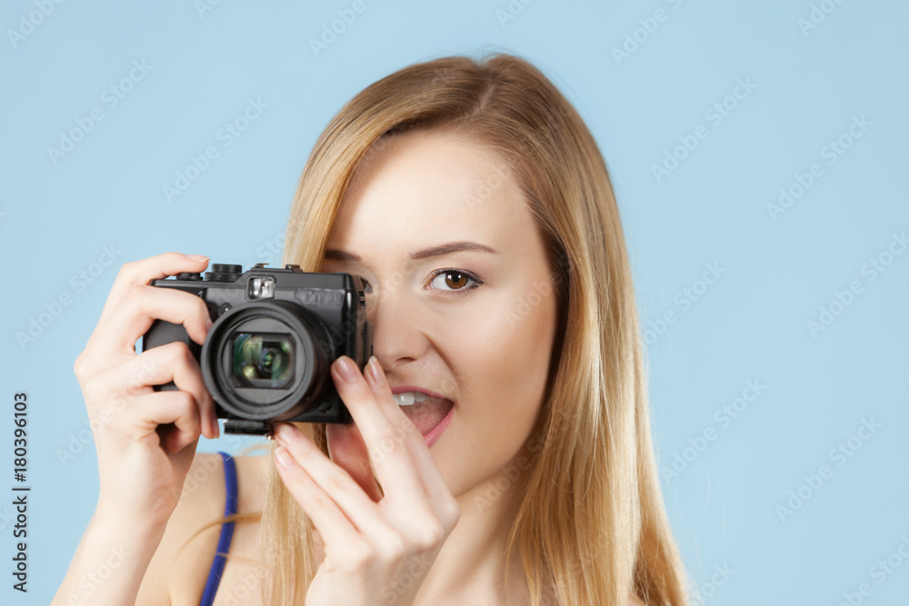 Blonde woman with camera on blue Blonde woman with camera on blue