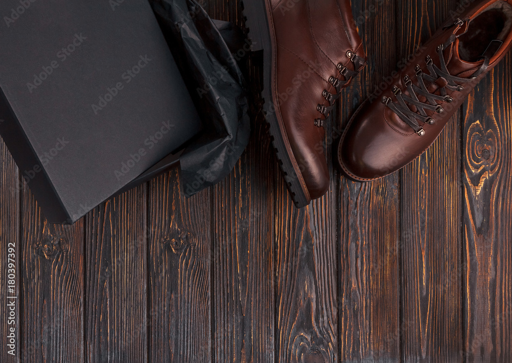 Man's shoes with box on a wooden background
