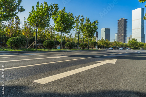 empty road and modern office block buildings against sky, china.