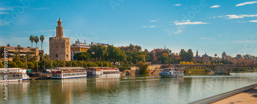 Seville, Spain, Gold tower (torre del oro) in a Seville panoramic view over Guadalquivir river.