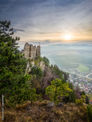 Ruins of a Castle on a Rockface in Gleissenfeld, Austria with Mountains and Village in Background. Located in Nature Park Seebenstein-Turkensturz.