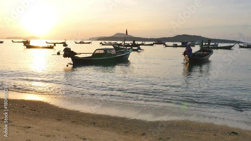 scenic reflection of beautiful sunshine in the sea fishing boats are on photo