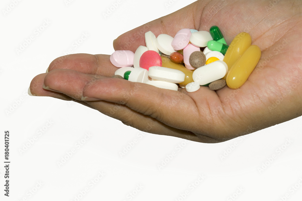 Medicine and vitamin in hand isolated on a white background. Medicine and vitamin in hand isolated on a white background.