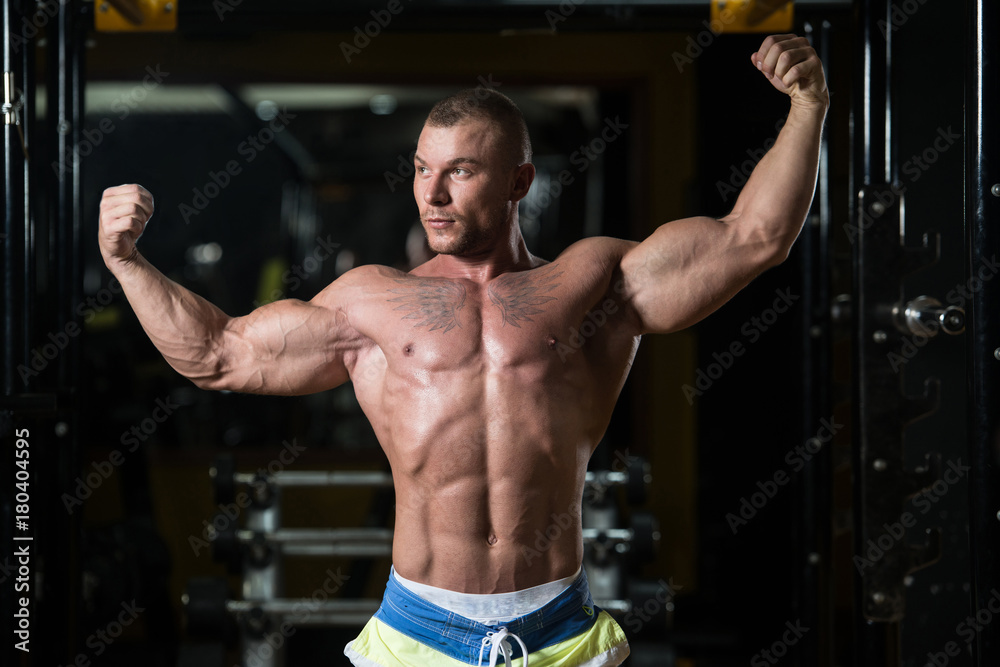 Bodybuilder Posing Biceps After Exercises