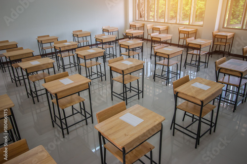 School empty classroom with test sheet or exams paper on desks chair wood and greenboard at high school thailand  education test concept