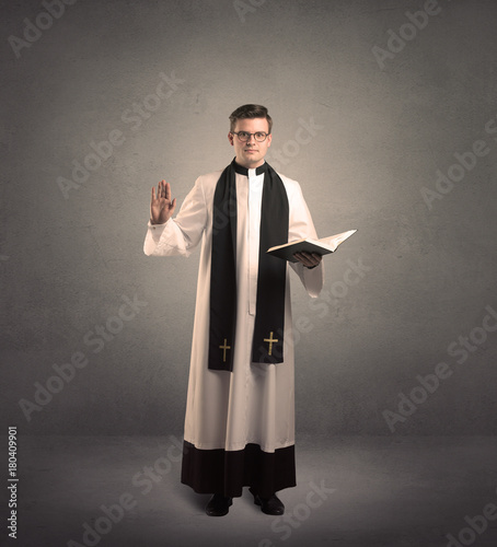Fototapeta young priest in giving his blessing