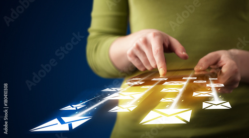 Hand holding tablet and sending email icons photo