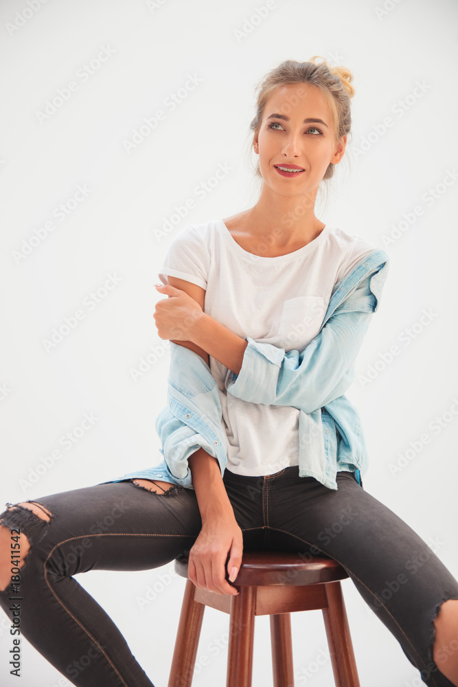 laughing casual woman sitting and looks away laughing casual woman sitting and looks away