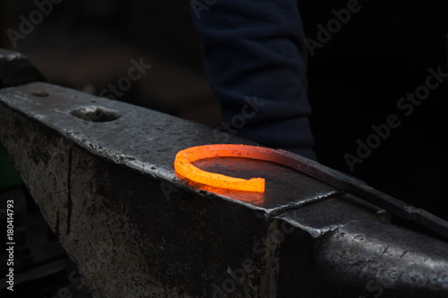 Making the horseshoe from heated red rod
