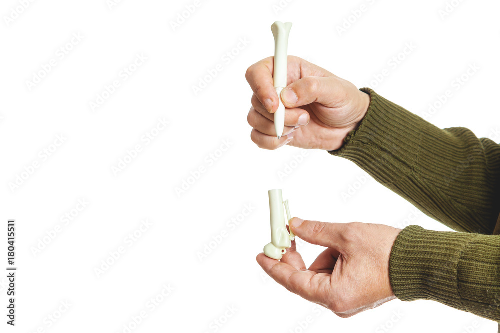 Hands holding ballpoint pen in form of stone Hands holding ballpoint pen in form of stone